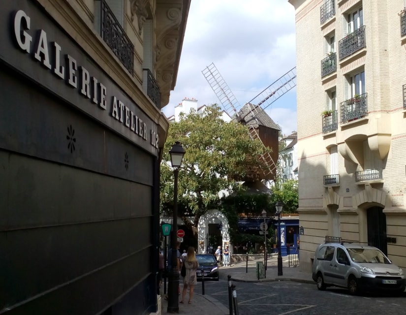 A view of the Radet windmill in Montmartre from Rue Lepic Paris 75018. The Radet windmill forms the entrance to the Moulin de la Galette restaurant.